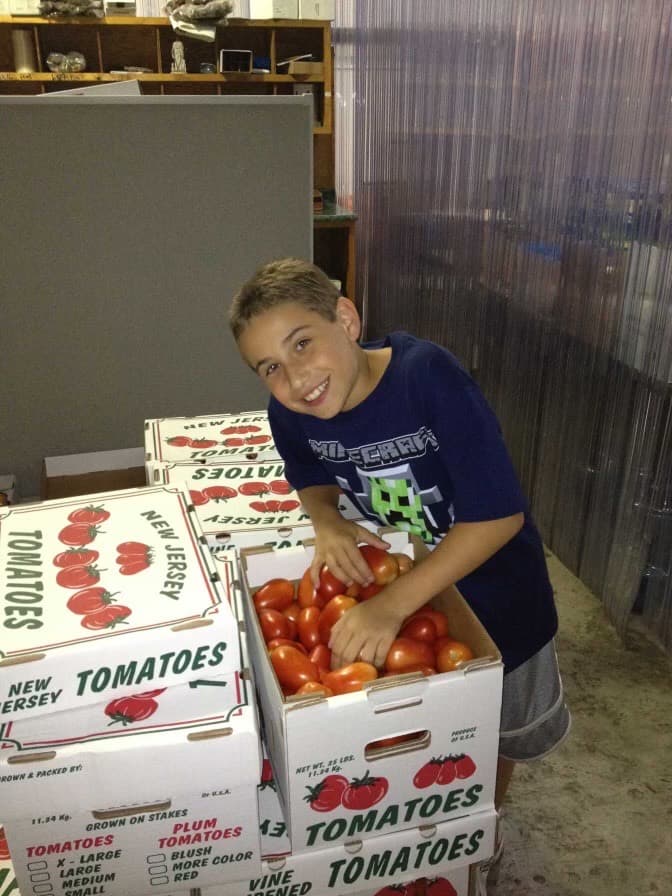 Joe Starkey as a child beside boxes of New Jersey tomatoes